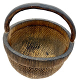 Wicker basket with a handle on a white background