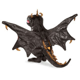 Dragon toy figure with open wings on a white background
