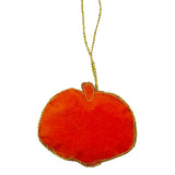 Orange pumpkin-shaped ornament with gold trim on a white background