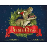 Children's book cover titled "Santa Claws" featuring a green dinosaur with sharp teeth wearing a red Santa hat, surrounded by ferns on a dark blue starry background. The title appears on a red ribbon banner, with credits for Bridget Heos and Galia Bernstein.
