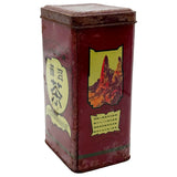 Vintage red tea tin with Chinese text and mountain design on a white background
